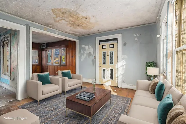 a living room with furniture a rug and a large window