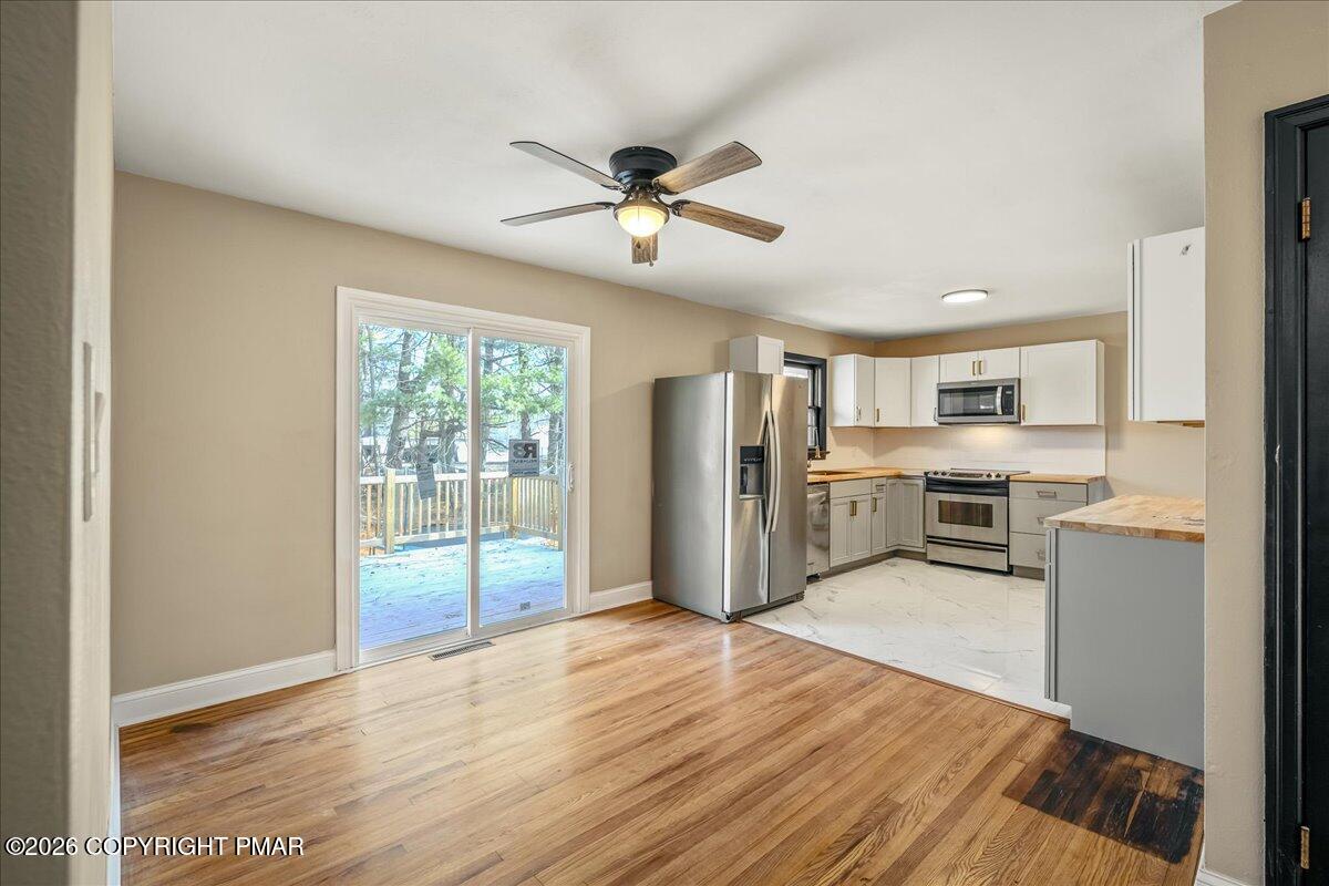7136 Howell Terrace Stroudsburg, PA 18360 - Photo 12 of 35 a view of kitchen with stainless steel appliances wooden floor and window