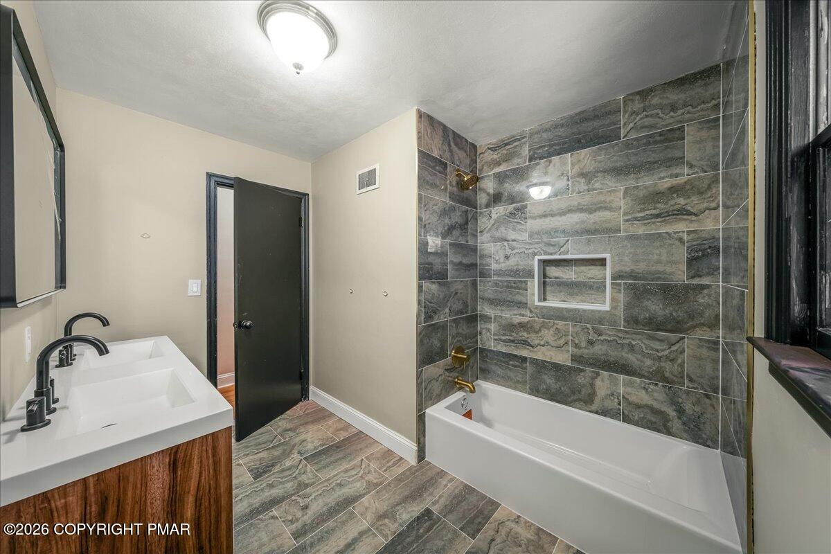 7136 Howell Terrace Stroudsburg, PA 18360 - Photo 14 of 35 a bathroom with a bathtub and a sink