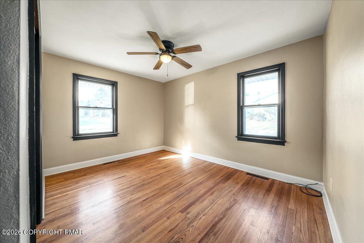 7136 Howell Terrace Stroudsburg, PA 18360 - Photo 16 of 35 a view of an empty room with wooden floor and a window