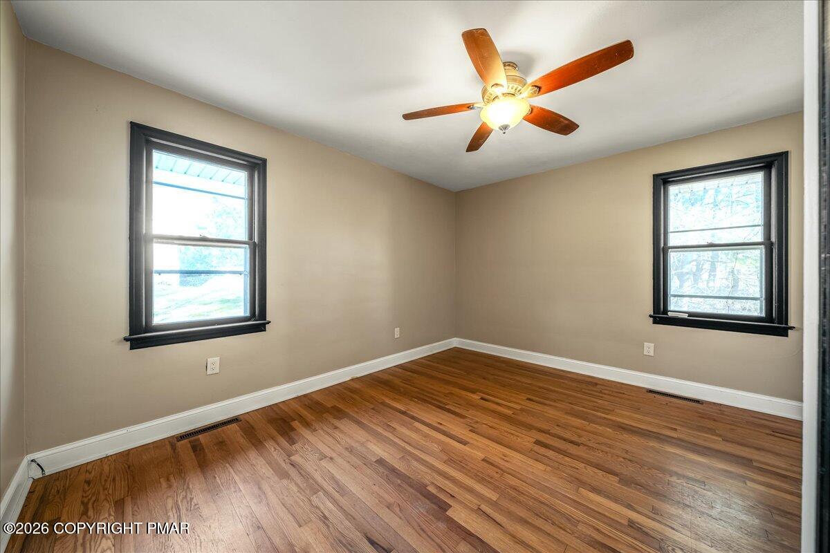 7136 Howell Terrace Stroudsburg, PA 18360 - Photo 18 of 35 a view of an empty room with wooden floor and a window