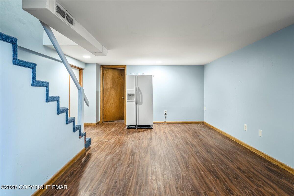 7136 Howell Terrace Stroudsburg, PA 18360 - Photo 22 of 35 a view of hallway with stairs and wooden floor