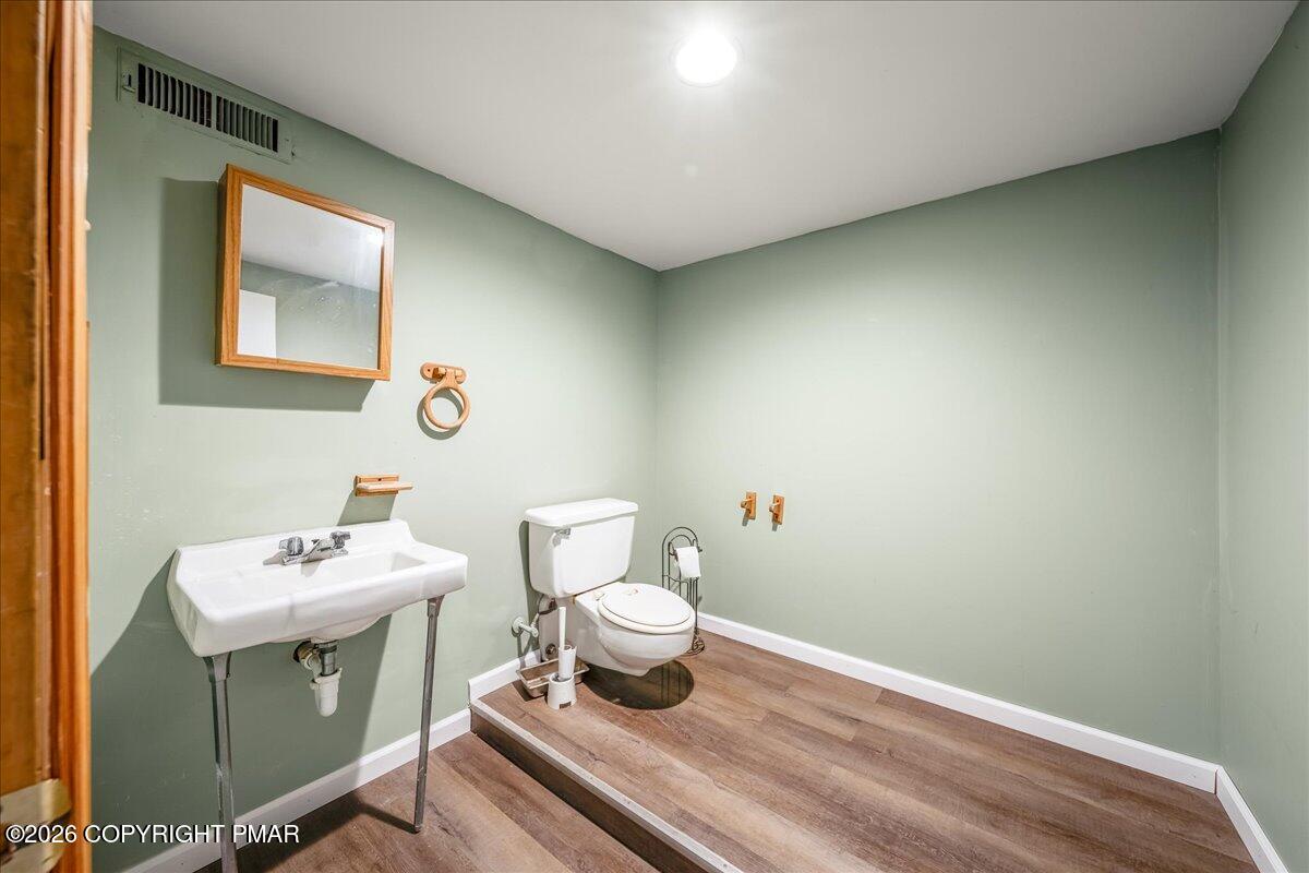 7136 Howell Terrace Stroudsburg, PA 18360 - Photo 24 of 35 a bathroom with a sink a toilet and a mirror