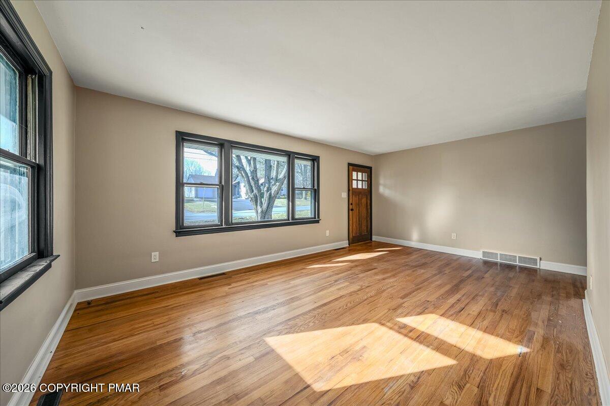 7136 Howell Terrace Stroudsburg, PA 18360 - Photo 5 of 35 an empty room with wooden floor and windows