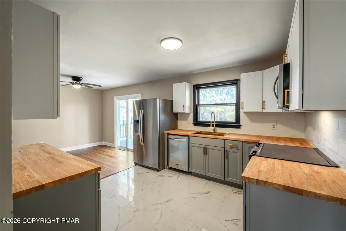 7136 Howell Terrace Stroudsburg, PA 18360 - Photo 6 of 35 a kitchen with stainless steel appliances granite countertop refrigerator sink and cabinets