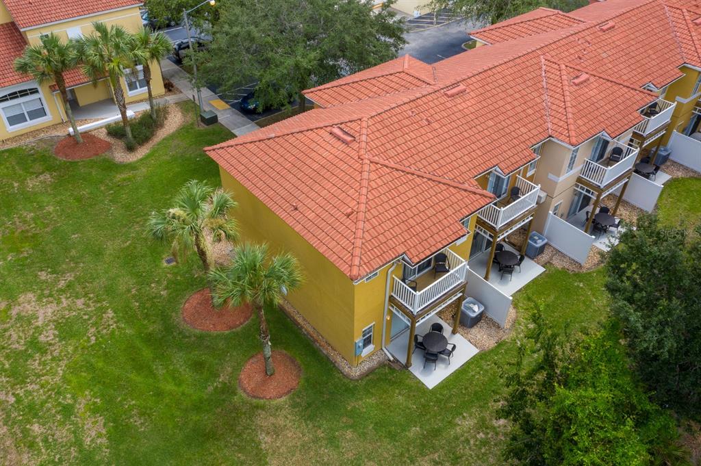 an aerial view of a house with a garden and trees