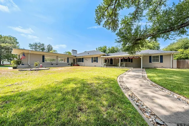 a view of a house with a swimming pool and a yard