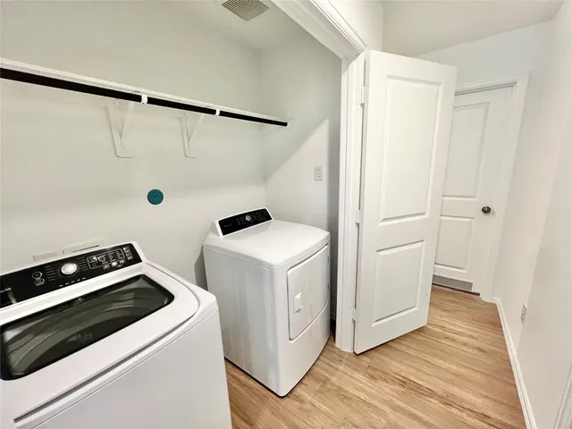 a view of storage and utility room with washer and dryer