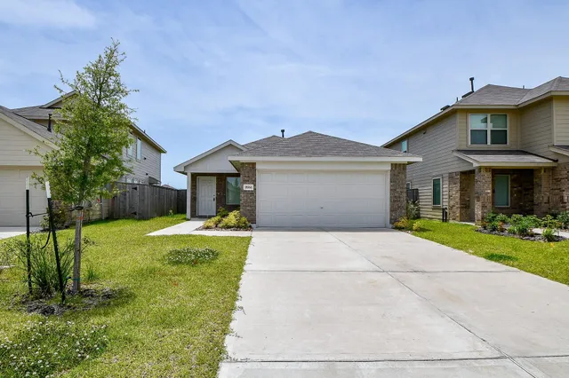 a front view of a house with a yard and porch