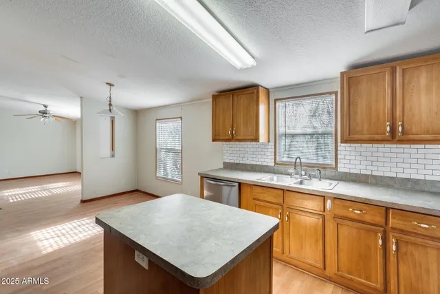 a kitchen with stainless steel appliances a refrigerator and a stove top oven