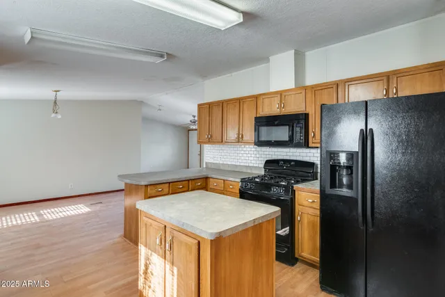 a kitchen with stainless steel appliances granite countertop a sink stove and cabinets