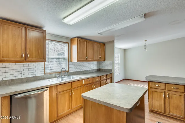 a view of a kitchen with a sink and a stove top oven