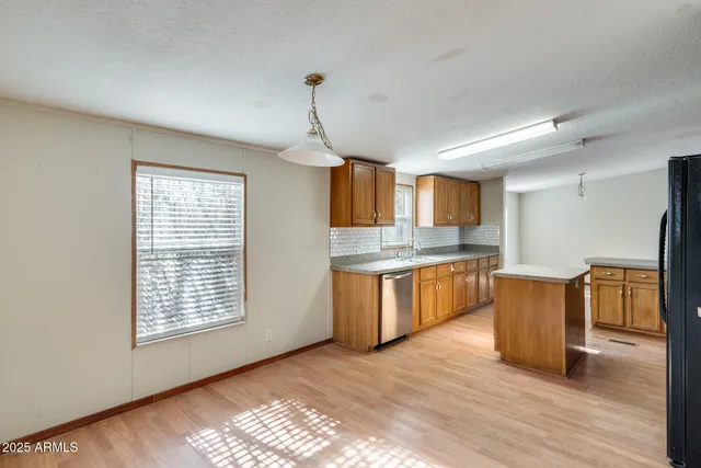 a view of a kitchen with a sink and a window