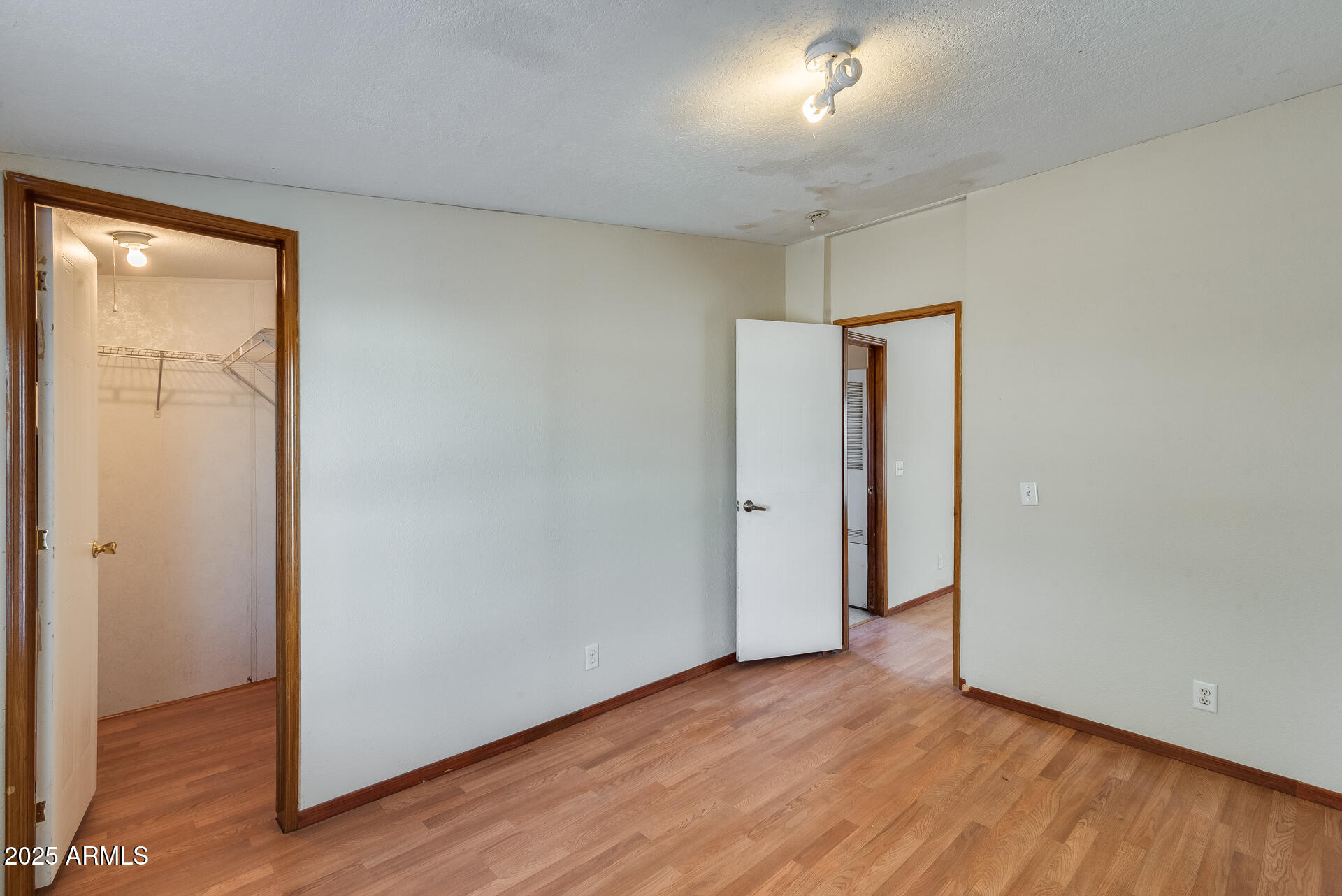 1047 South Main Street Coolidge, AZ 85128 - Photo 21 of 72 a view of an empty room with wooden floor and closet