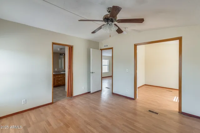 an empty room with wooden floor and closet