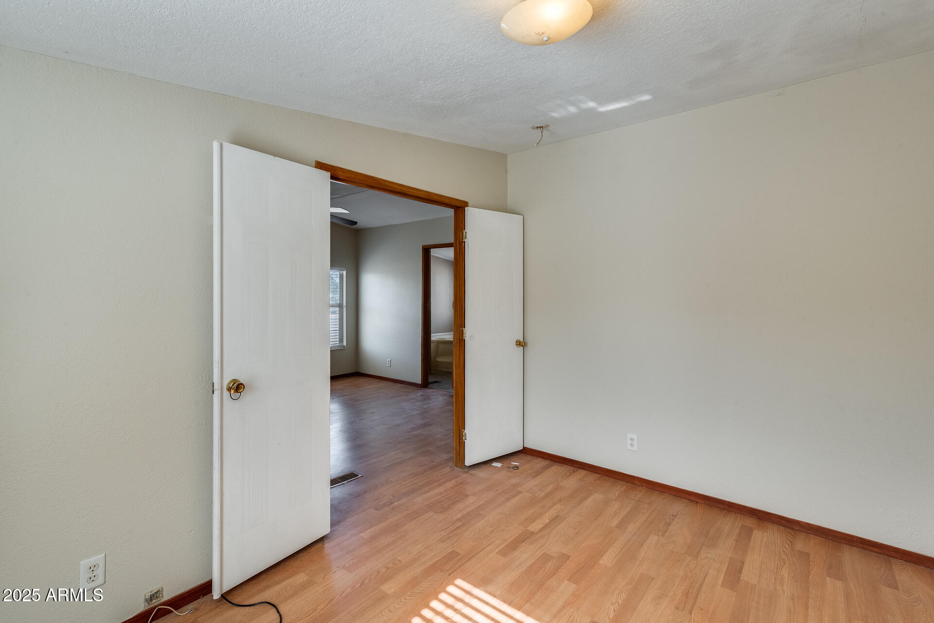 1047 South Main Street Coolidge, AZ 85128 - Photo 30 of 72 an empty room with wooden floor and closet