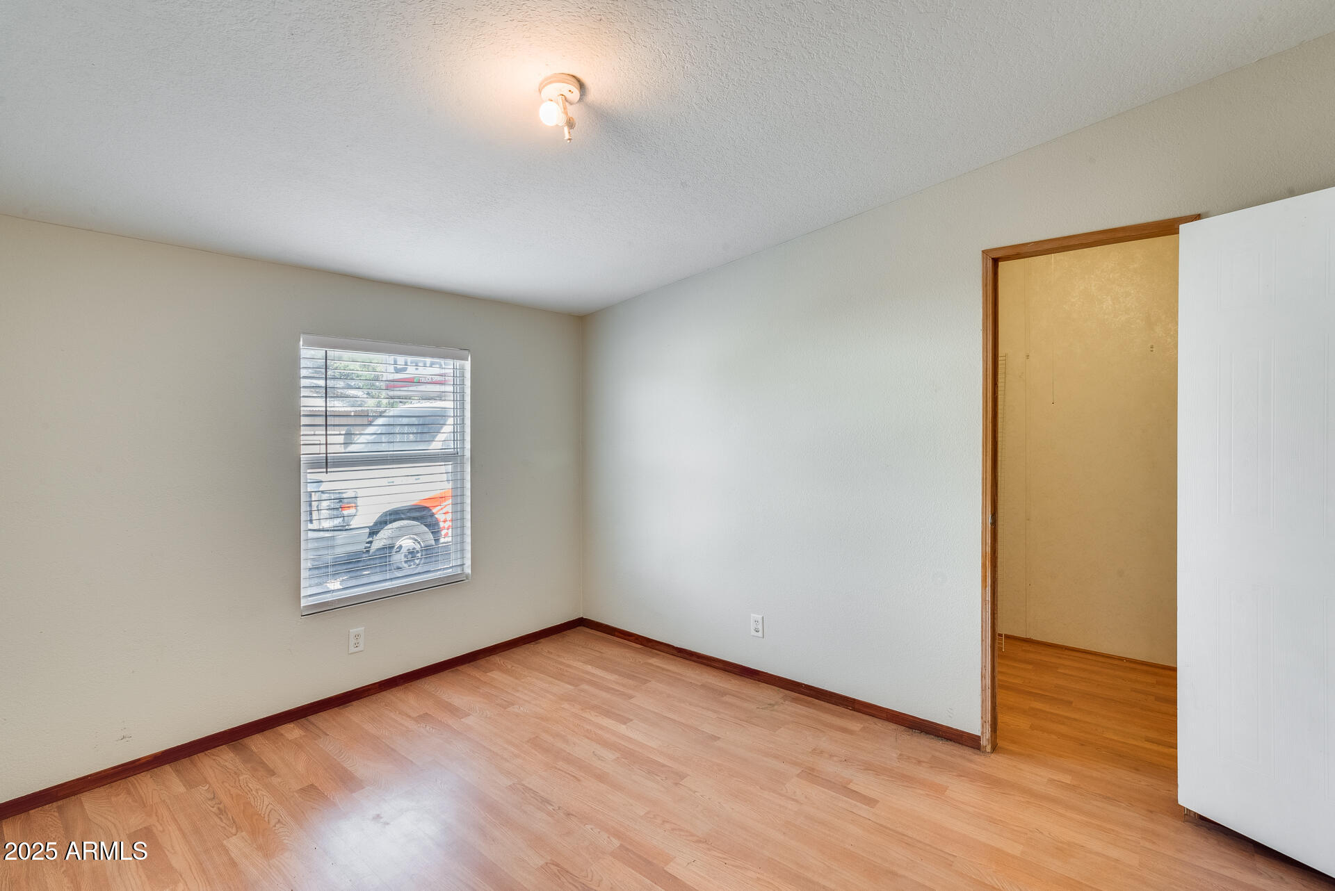 1047 South Main Street Coolidge, AZ 85128 - Photo 31 of 72 an empty room with wooden floor and windows