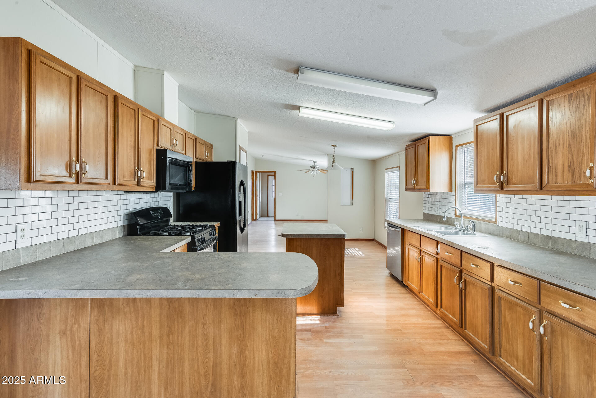 1047 South Main Street Coolidge, AZ 85128 - Photo 10 of 72 a kitchen with stainless steel appliances granite countertop a sink a stove top oven a counter space and cabinets