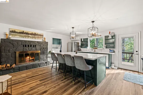 a kitchen with kitchen island granite countertop a sink and a stove
