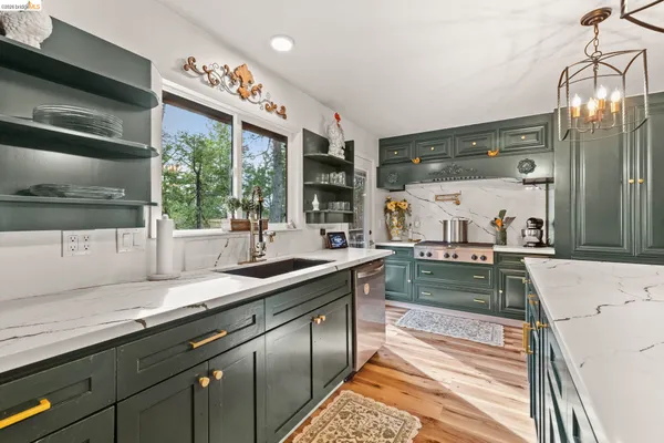 a kitchen with a sink a counter space and stainless steel appliances