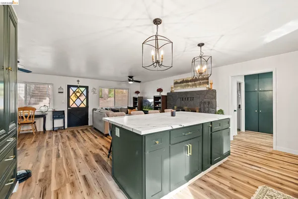 a kitchen with kitchen island granite countertop a sink and stove