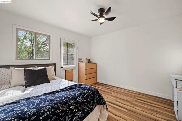 a backyard of a house with barbeque oven table and chairs