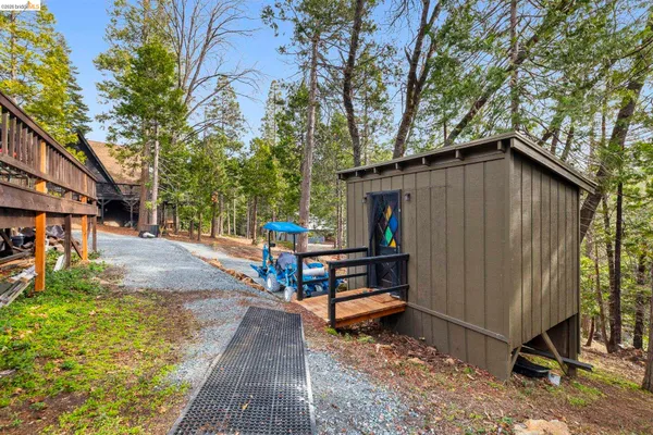 a backyard of a house with table and chairs