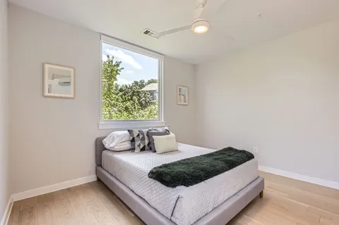 a bedroom with a large bed and a window