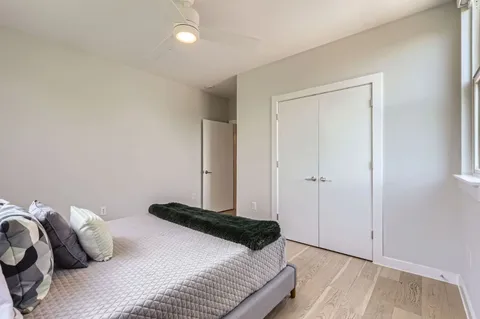 a bedroom with a bed and a night stand
