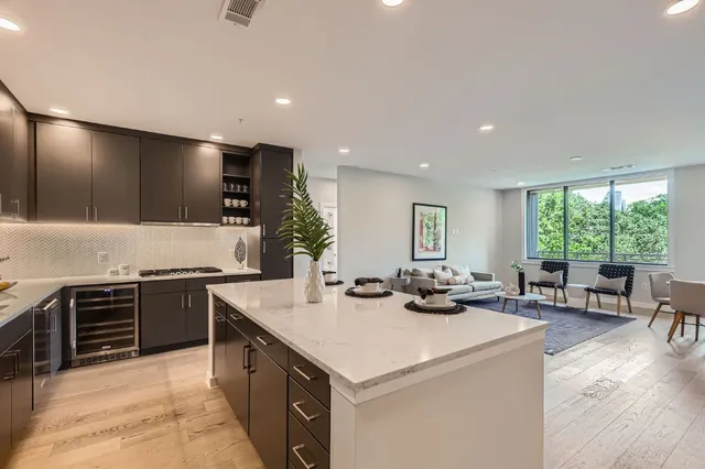 a kitchen with stainless steel appliances granite countertop a stove and a sink