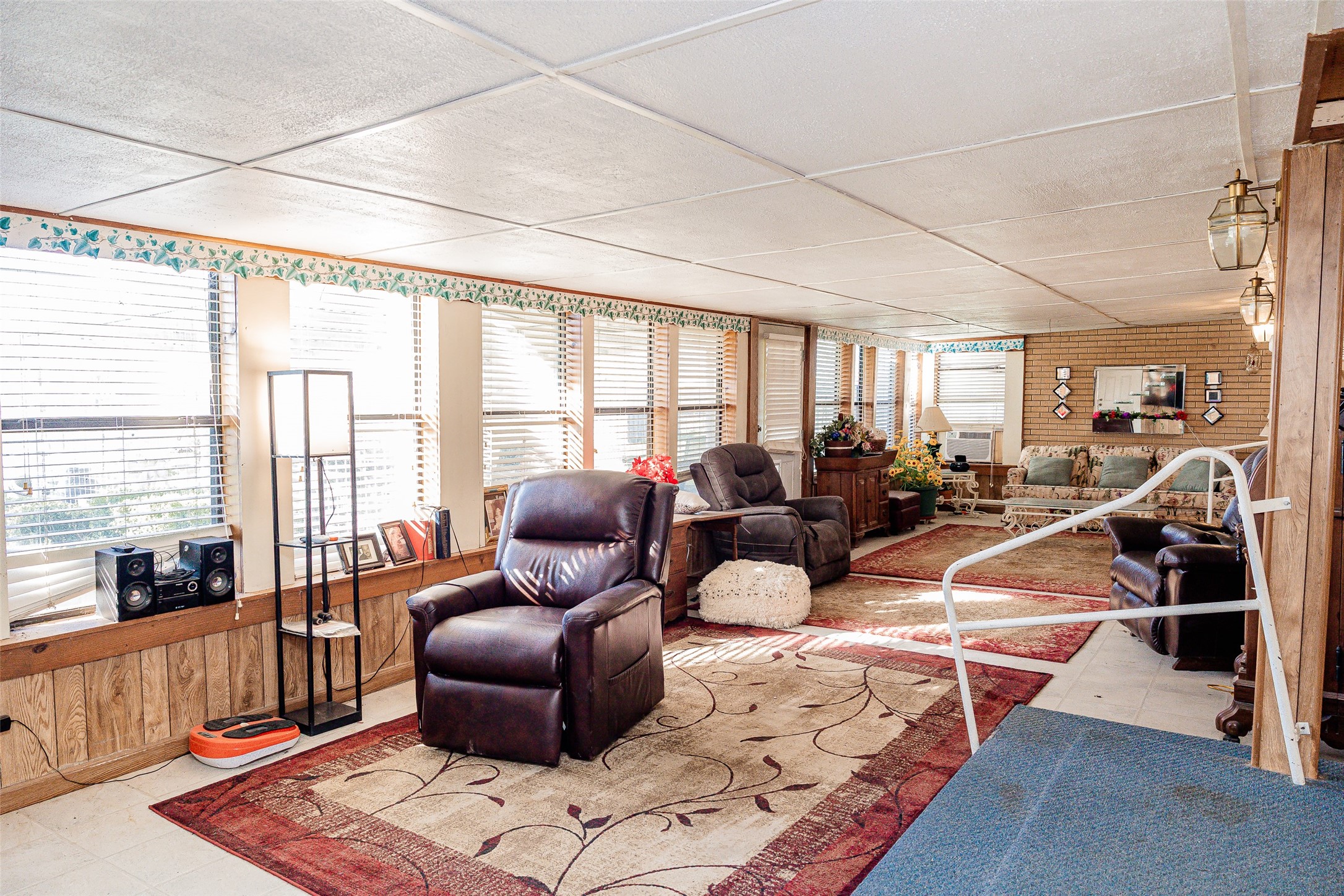 8608 Captain Scott Road Brenham, TX 77833 - Photo 18 of 28 a living room with furniture and a floor to ceiling window