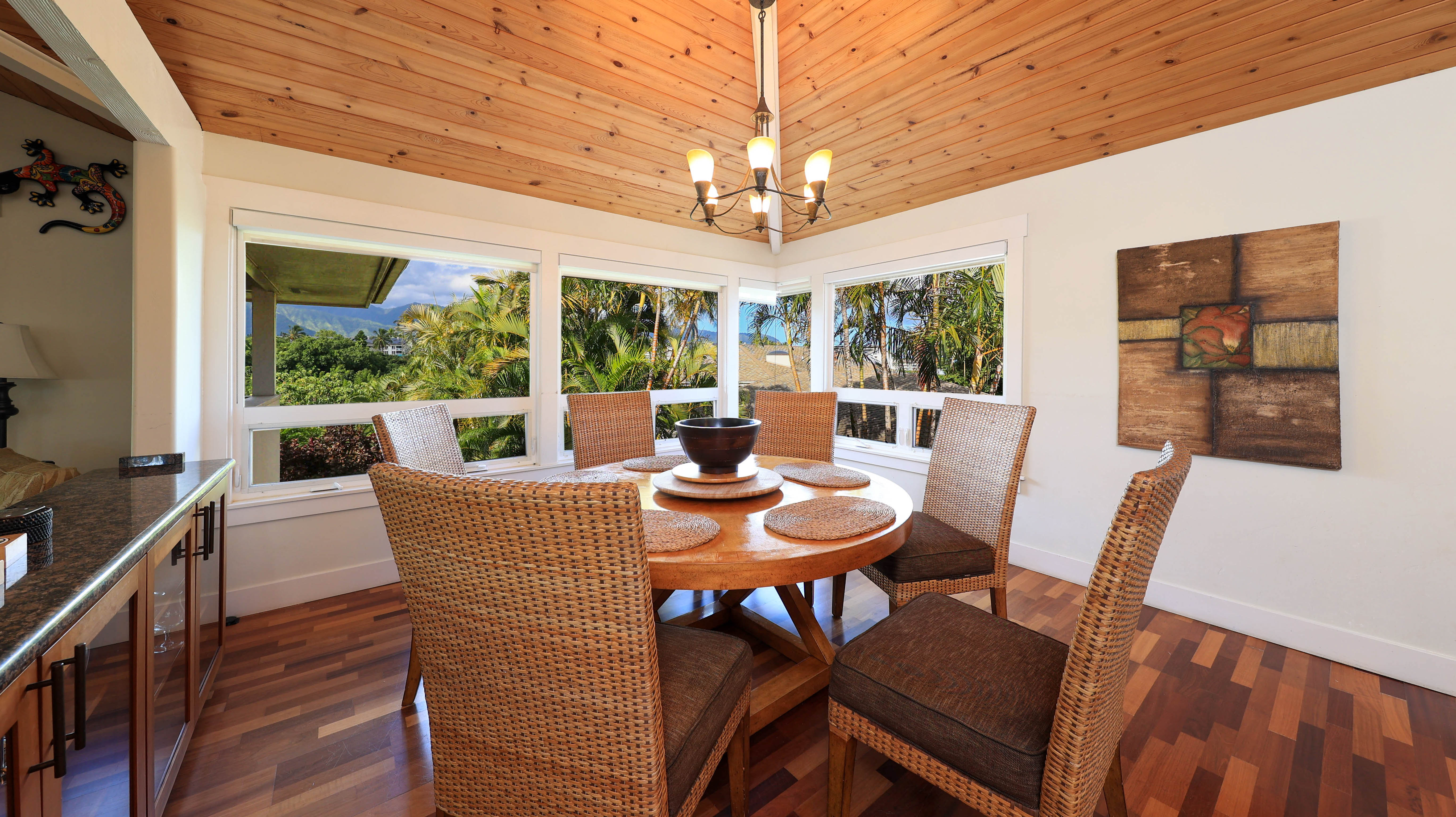 3570 Kaweonui Road Princeville, HI 96722 - Photo 11 of 30 a view of a dining room with furniture a chandelier and wooden floor