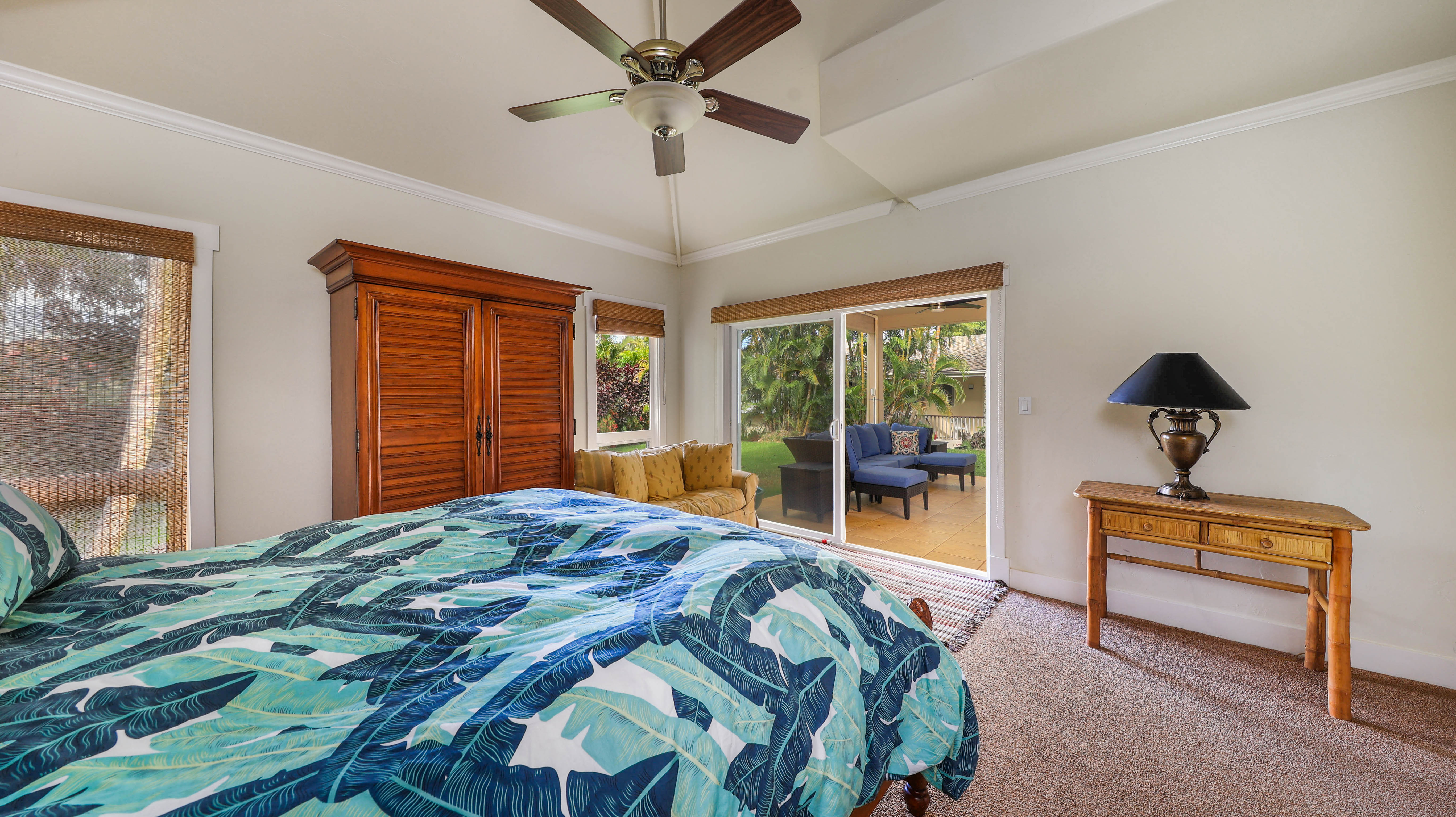 3570 Kaweonui Road Princeville, HI 96722 - Photo 21 of 30 a bedroom with a bed and a dresser next to a window