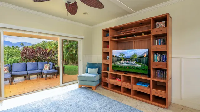a living room with furniture and a floor to ceiling window