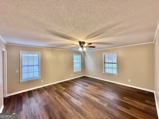 a view of walk in closet with wooden floor