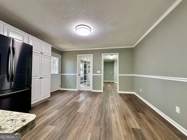 a kitchen with granite countertop a sink stove and cabinets