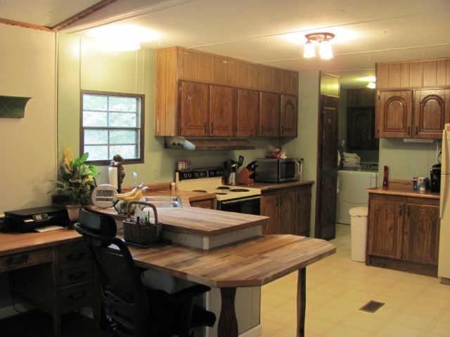 212 Duckworth Road Winchester, TN 37398 - Photo 4 of 16 a kitchen with a table chairs sink and cabinets