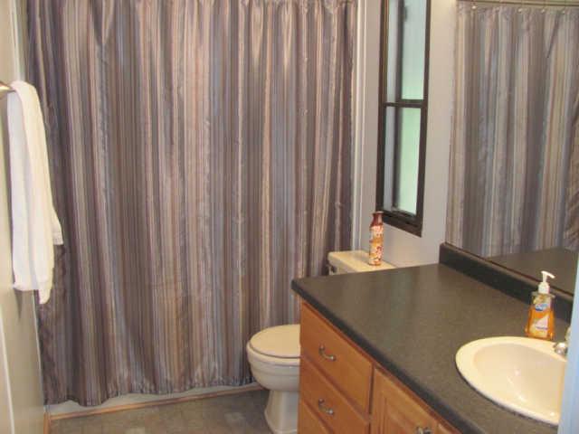 212 Duckworth Road Winchester, TN 37398 - Photo 6 of 16 a bathroom with a granite countertop sink toilet and a mirror