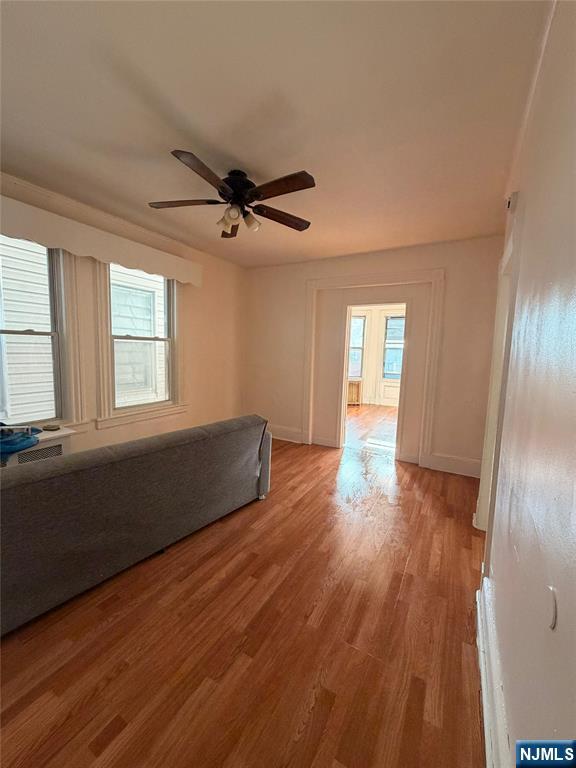 113 Martin Street, Unit 1 Paterson, NJ 07501 - Photo 2 of 14 a living room with hardwood floor and a window