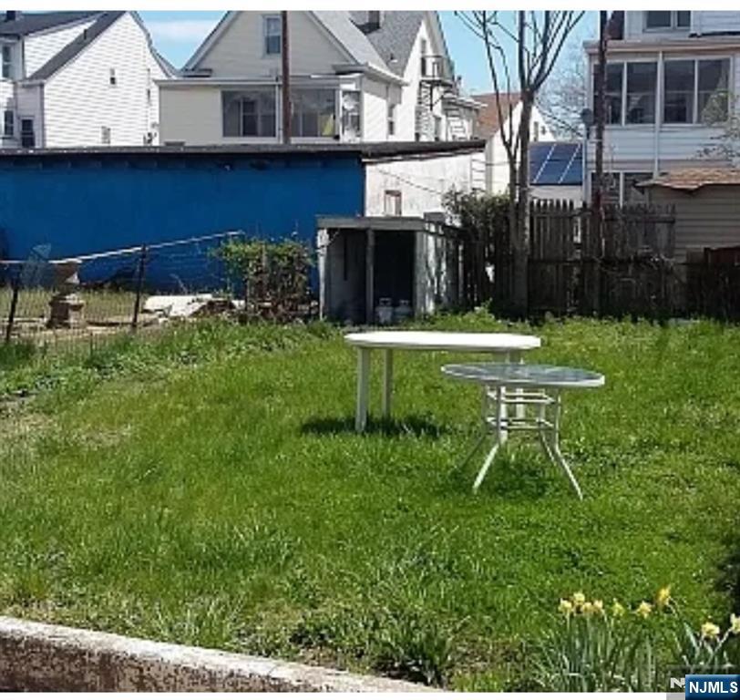 113 Martin Street, Unit 1 Paterson, NJ 07501 - Photo 4 of 14 a view of a chair and table and chair in the grass