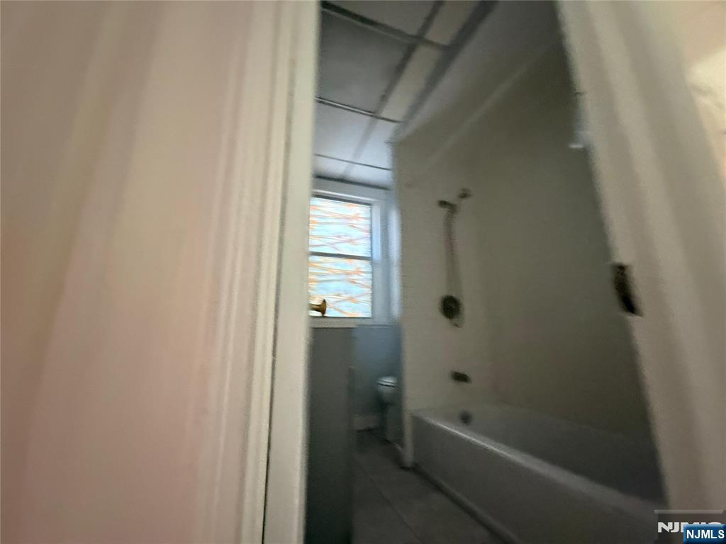 113 Martin Street, Unit 1 Paterson, NJ 07501 - Photo 8 of 14 a bathroom with a bathtub