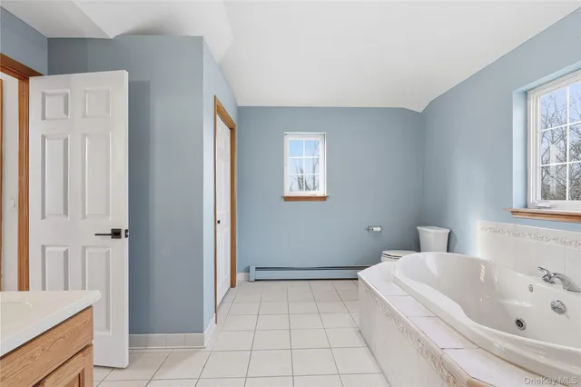 a bathroom with a tub shower and sink