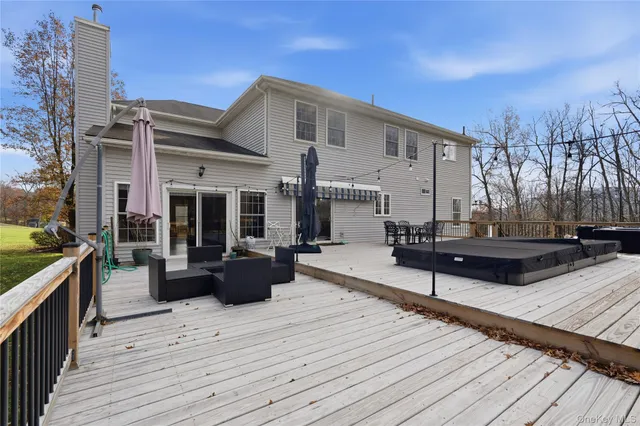 a view of a house with barbeque grill and wooden floor