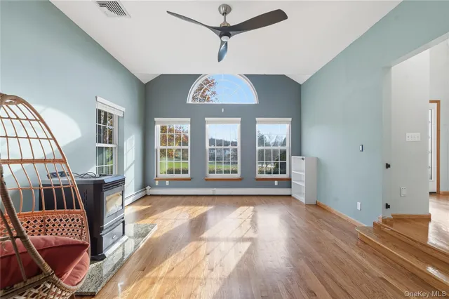 a view of front door with furniture and wooden floor