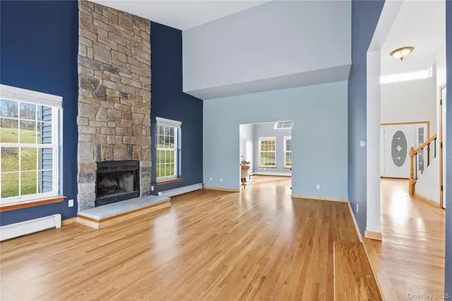 a view of a livingroom with wooden floor and a fireplace