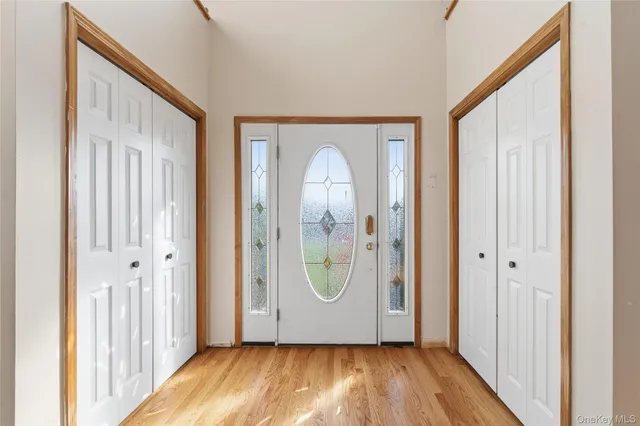a view of an entryway with wooden floor and door