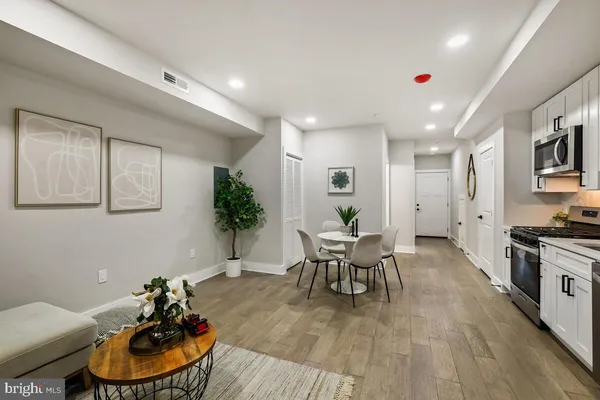 a living room with furniture and a wooden floor