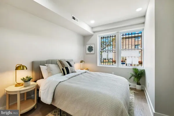 a bedroom with a bed and a window