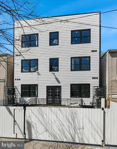 a view of a house with wooden fence