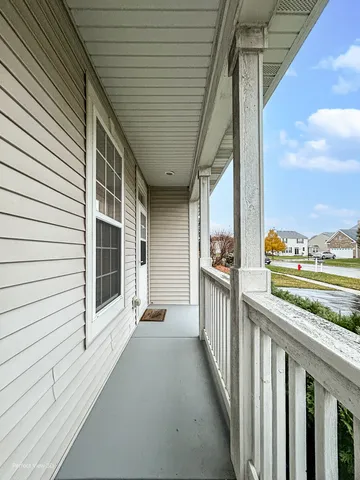 a view of a porch with wooden floor